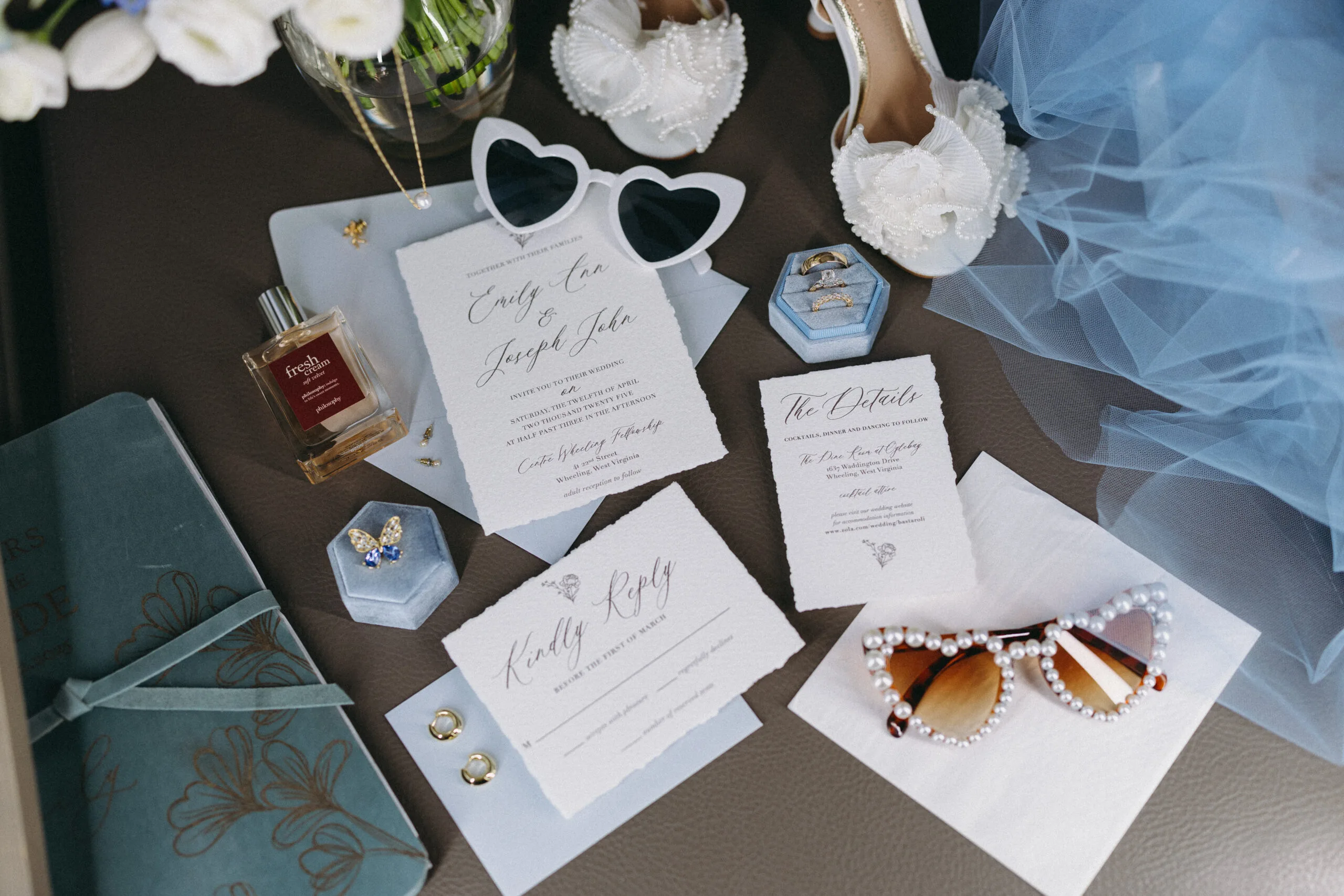 Wedding invitation suite arranged in a flat lay with envelopes