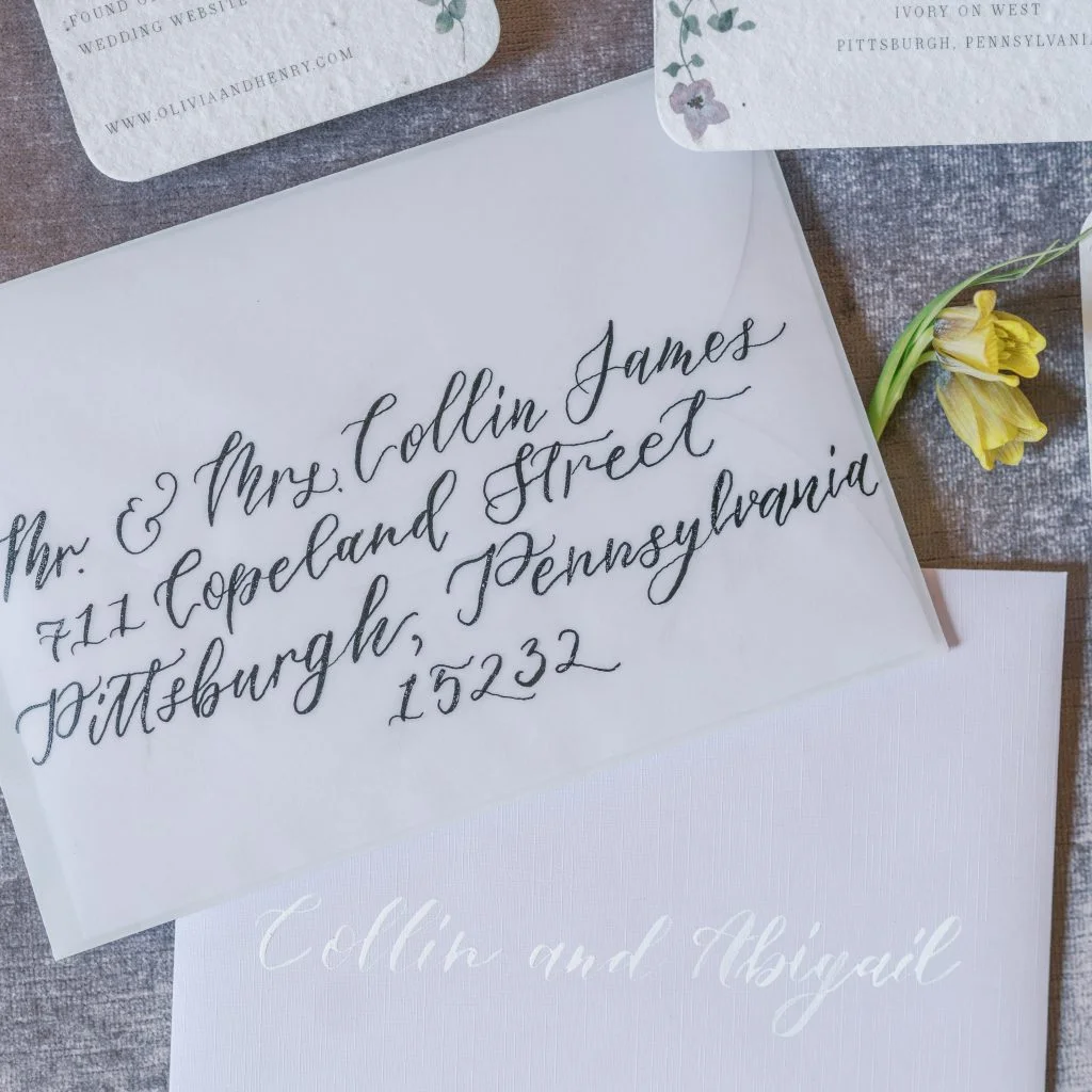 Vellum wedding envelope addressed in calligraphy on a neutral background